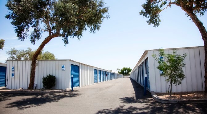 A row of outdoor storage units with blue doors