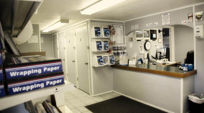 Facility office with moving and packing supplies hanging on walls and shelves