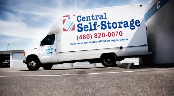 A Central Self Storage moving truck parked outside of facility by storage units