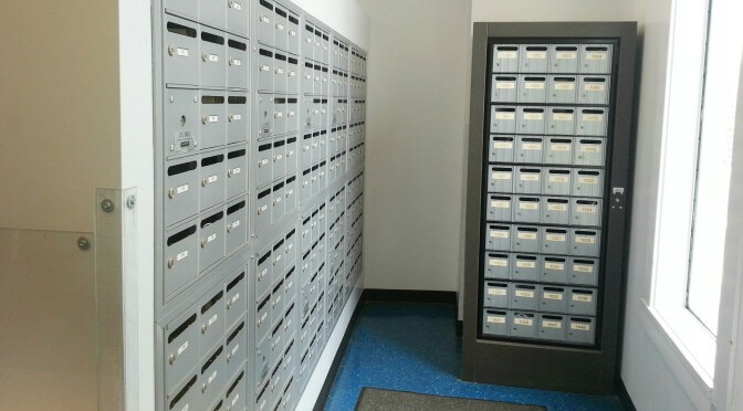 Mail room with several rows of mailboxes