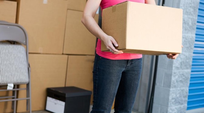 woman with box outside of storage unit