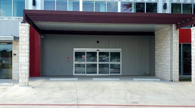 Automatic sliding door at entrance of facility.