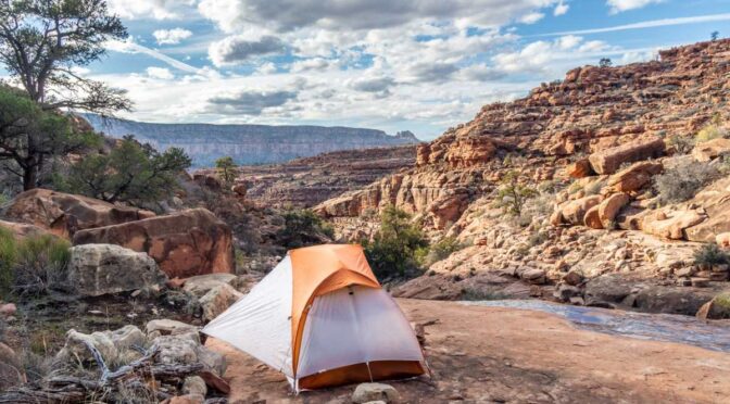 A camping tent sits outside in the beautiful mountains of Arizona.