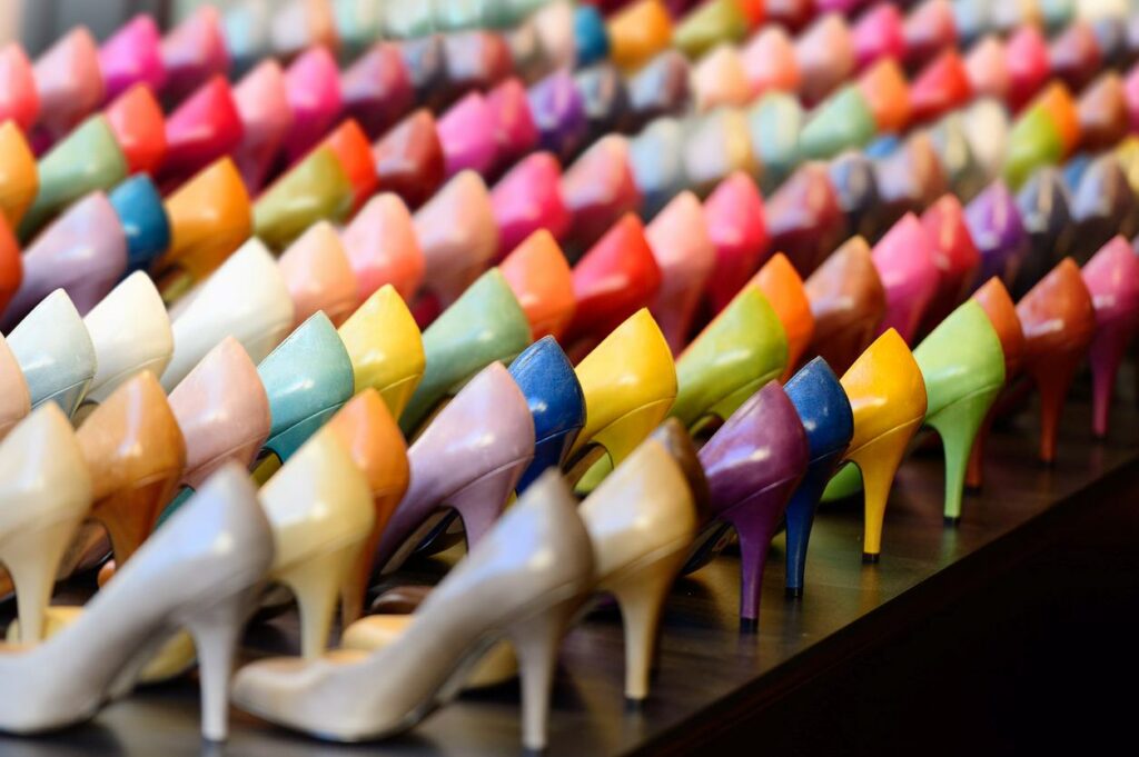 An array of many different colored heels on display
