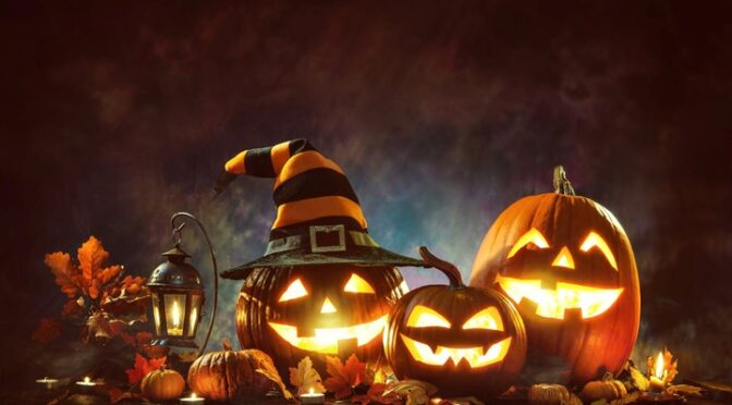 Several jack-o’-lantern pumpkins are sitting on a wooden table.